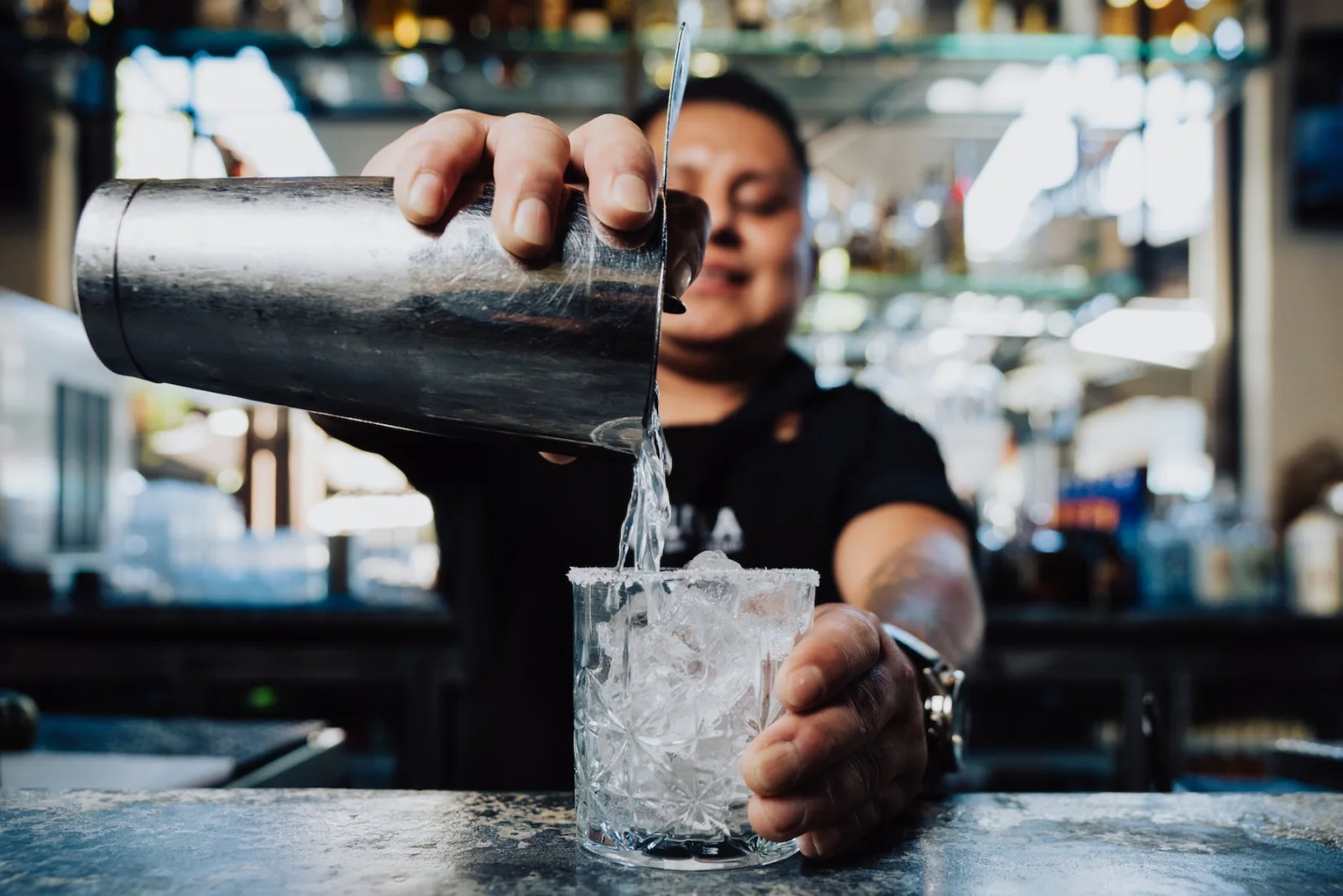 A LUNA bartender pouring a freshly prepared cocktail