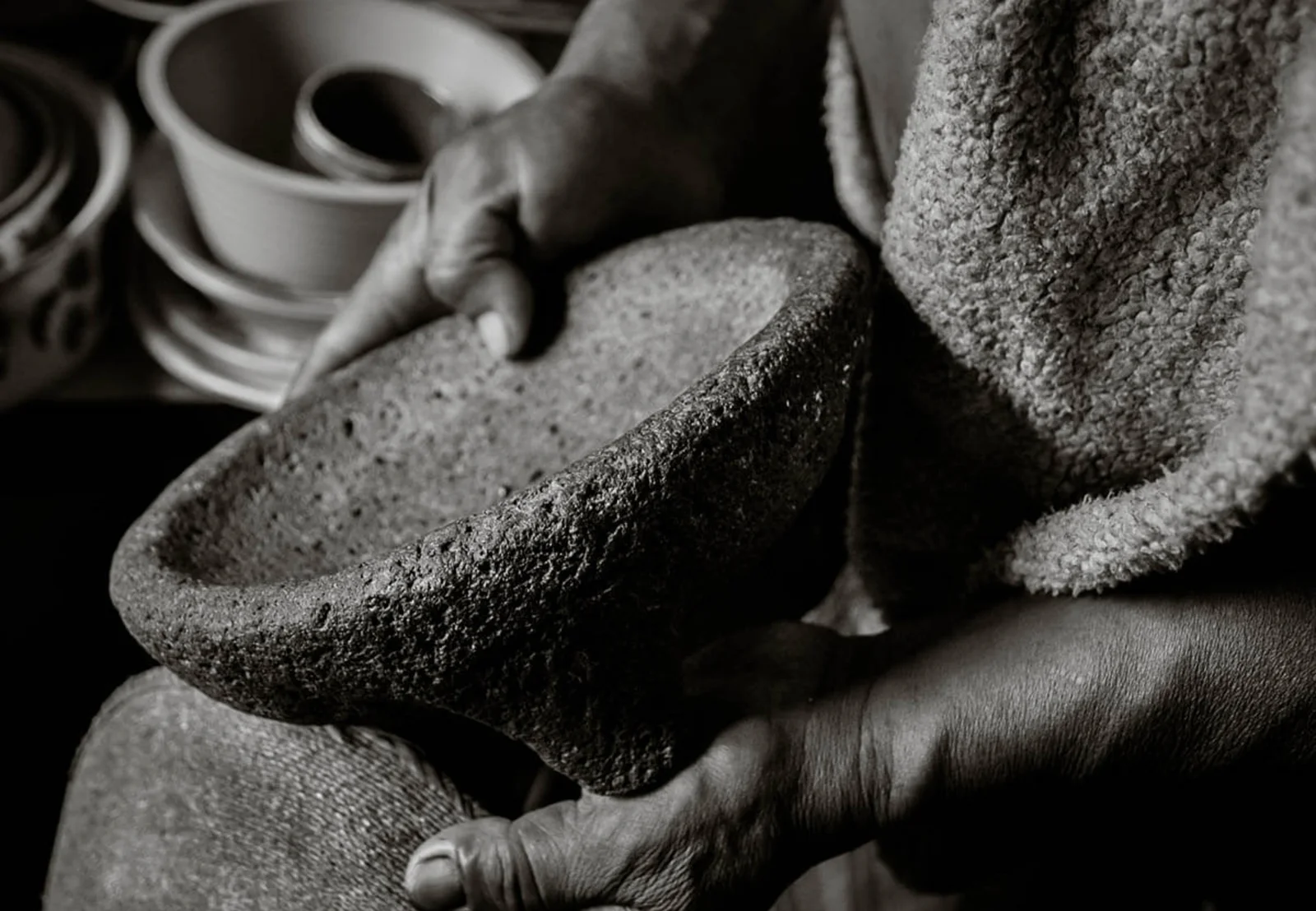 Hands holding a traditional stone molcajete at LUNA